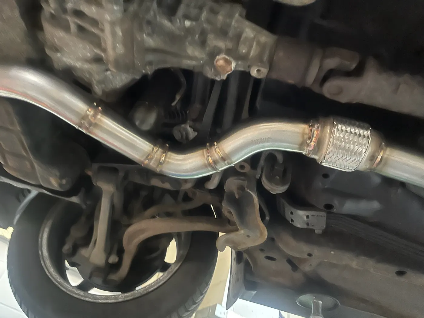 Exhaust system fabrication underneath a car at Goblin Automotive